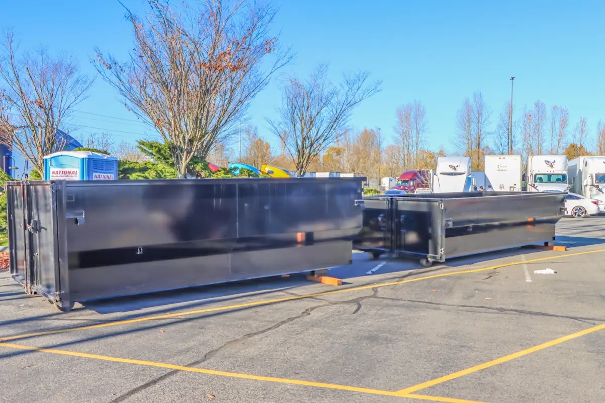 Professional dumpster rental service with roll-off container on residential driveway in Red Chute